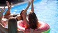 Beautiful hot pretty girls in bikini have pool party dancing with inflatable watermelon floaty mattress. Glamour fitted