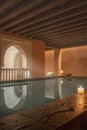 Beautiful hot spring pool in Arab baths with candles, reflections, numid arches,