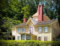 Beautiful house with green trees and shrubs in New England, Massachusetts on a sunny day Royalty Free Stock Photo