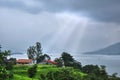 beautiful house of Indian village under dramatic sky with sun rays Royalty Free Stock Photo