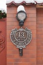 Beautiful house number on a brick pillar with a lantern