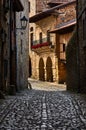 Beautiful house with a roses in the balcony in a picturesque old street of Santilla del Mar, Spain Royalty Free Stock Photo