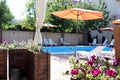 Beautiful house, swimming pool view from the veranda, summer day Royalty Free Stock Photo