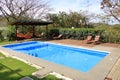 beautiful house swimming pool view from the veranda, summer day Royalty Free Stock Photo