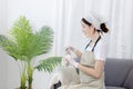 Beautiful housewife is cleaning things and vases in the living room