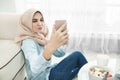 Beautiful housewife wearing hijab taking selfies in a leisure ti Royalty Free Stock Photo