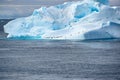 Huge Iceberg, Roosting Place For Penguins And Cormorants. Blue And Turquoise Iceberg In Antarctica With Many Animals. Sharp Photo