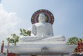 Beautiful huge white statue of Buddha on the roof of the temple in Colombo