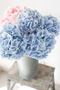 Beautiful hydrangea flowers in a vase on a table . Bouquet of light blue. Decoration of home. Wallpaper and background. Royalty Free Stock Photo