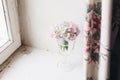 Beautiful hydrangea flowers in vintage glass with water on rustic white wood of old windowsill. Countryside still life. Happy Royalty Free Stock Photo