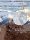 Beautiful ice piece on stone on lake coast, Lithuania Royalty Free Stock Photo