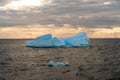 Beautiful iceberg floating in the water. Photo taken at sunset in Antarctica and Arctic Greenland. Global warming and