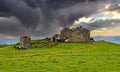 Beautiful icelandic lonely quiet rural landscape, abandoned old idyllic farm house ruin on green hill with herd horses, dark storm