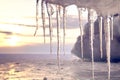 Beautiful icicles shine in sun against sunset. Winter time at Lake Baikal Royalty Free Stock Photo