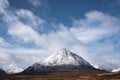 Beautiful iconic landscape Winter image of Stob Dearg Buachaille Etive Mor mountain in Scottish Highlands againstd vibrant blue