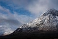 Beautiful iconic landscape Winter image of Stob Dearg Buachaille Etive Mor mountain in Scottish Highlands againstd vibrant blue