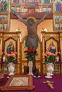 Beautiful icons with roses in flower pots. Religious images in christian cathedral. Religious art. Christian church interior.