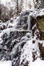 Beautiful icy waterfall in the forest. Vosges mountains. Royalty Free Stock Photo