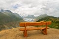 Beautiful idyllic Alps landscape with wooden bench on viewpoint, mountains in Switzerland
