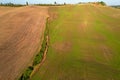 Beautiful idyllic summer landscape of Toscana with many mediterranean plants, hills, trees and fields.