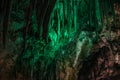 Beautiful illuminated limestone stalactites in Adygeya underground cave
