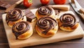 Chocolate swirl buns on wooden chopping board