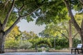 Beautiful image of a bench in a square in the middle of a park with leafy trees