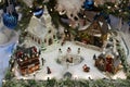 Beautiful image of Christmas village, with buildings and ornaments under decorated pine tree Royalty Free Stock Photo