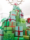 Beautiful high Chrsitmas tree made of boxes with holiday gifts