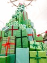 Beautiful high Chrsitmas tree made of boxes with holiday gifts