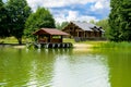 A beautiful image of a landscape from the center of a river surrounded by trees and reeds on the shore against a blue sky in