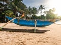 Beautiful image of old traditional fishing wooden boat on the sandy ocean beach at sunset Royalty Free Stock Photo