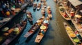 Beautiful image of popular Thailand landmark destination floating market on the calm river water. Sellers offering fruits and