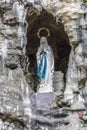 Image of the replica of the Virgin of Lourdes in a natural grotto Royalty Free Stock Photo