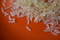 Rice on orange, detailed image of groats Royalty Free Stock Photo