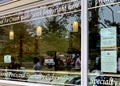 Reflections of people through a window enjoying ice cream outside a specialty store in Port Moody, Oct 1st 2020