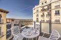 Beautiful image of a terrace with an outdoor circular white table with matching chairs with breakfast cups and views in the middle