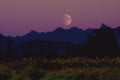 Beautiful image of a vivid purple moonrise over a majestic mountain range Royalty Free Stock Photo