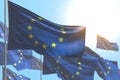 Beautiful independence day flag 3d illustration - many European Union flags are wave against blue sky picture with bokeh
