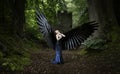 Beautiful Indian Asian girl with black wings in blue dress in front of a castle keep Royalty Free Stock Photo