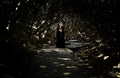 Beautiful Indian Asian model dressed in black cloak lost in the labyrinth Royalty Free Stock Photo