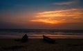 Beautiful Indian beach at the evening with dramatic sky and silhouette boats in the foreground