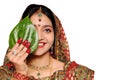 Beautiful Indian bride in red sari holding a leaf.