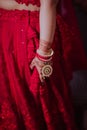 Beautiful Indian Bride in traditional Hindu wedding attire with lehnga, bridal bangles and shy pose Royalty Free Stock Photo