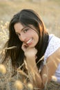 Beautiful indian brunette in a golden field Royalty Free Stock Photo