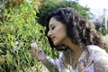 Beautiful Indian girl with eyes closed smelling a white rose Royalty Free Stock Photo