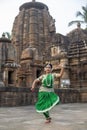 Beautiful indian girl dancer of Indian classical dance Odissi posing in front of Mukteshvara Temple, Bhubaneswar, Odisha, India.Od