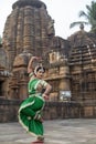 Beautiful indian girl dancer of Indian classical dance Odissi posing in front of Mukteshvara Temple, Bhubaneswar, Odisha, India.Od