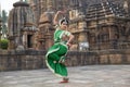 Beautiful indian girl dancer of Indian classical dance Odissi posing in front of Mukteshvara Temple, Bhubaneswar, Odisha, India.Od