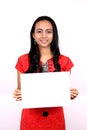 Beautiful Indian girl holding a white banner.